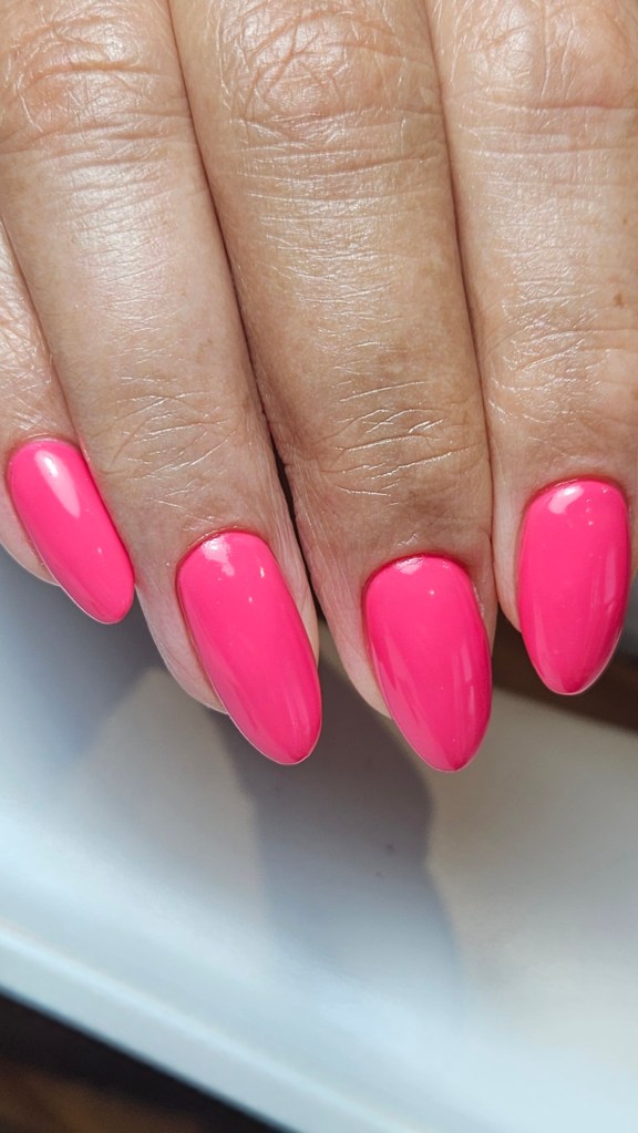 Bright neon pink hard gel nails in an almond shape - Amy Suchowij Nail Salon Ipswich